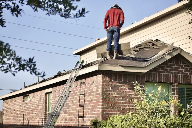 Professional roofer working on a residential roof in O'Shanter Estates